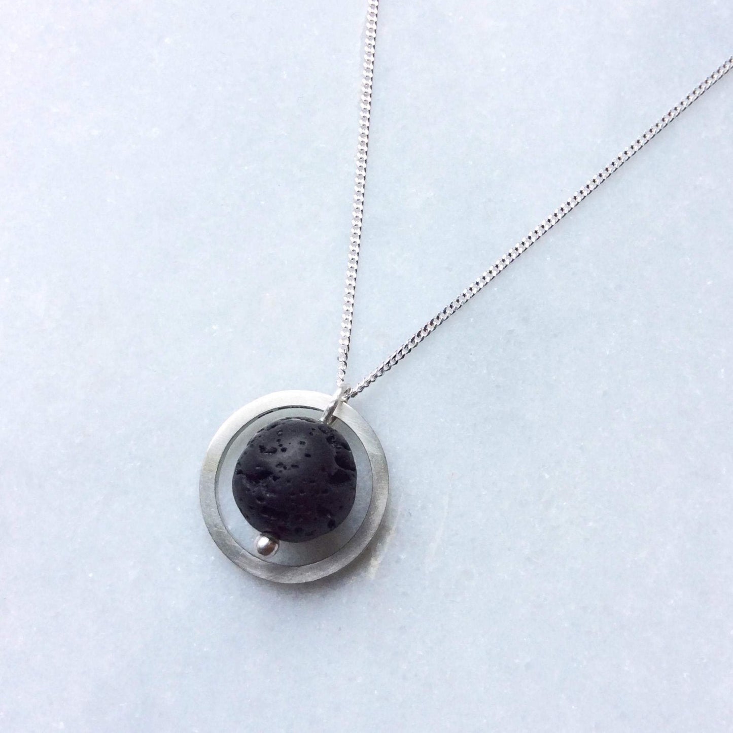 SILVER CIRCLE LAVA STONE DIFFUSER NECKLACE - Genevieve Broughton