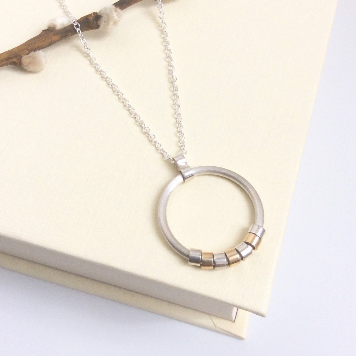 CIRCLE NECKLACE WITH SILVER AND GOLD MOVING PIECES - Genevieve Broughton