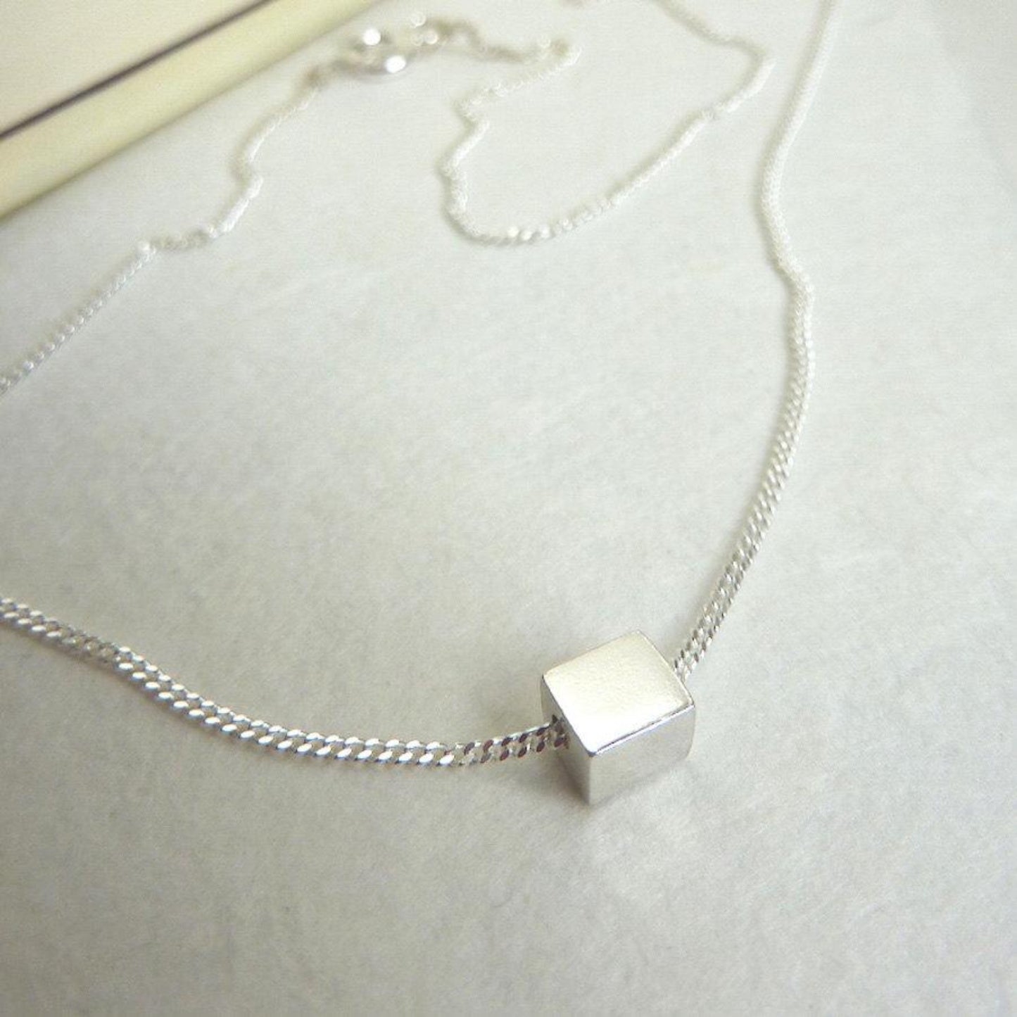 TINY SILVER CUBE NECKLACE - Genevieve Broughton