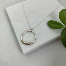 Load image into Gallery viewer, CIRCLE NECKLACE WITH SILVER AND GOLD MOVING PIECES - Genevieve Broughton
